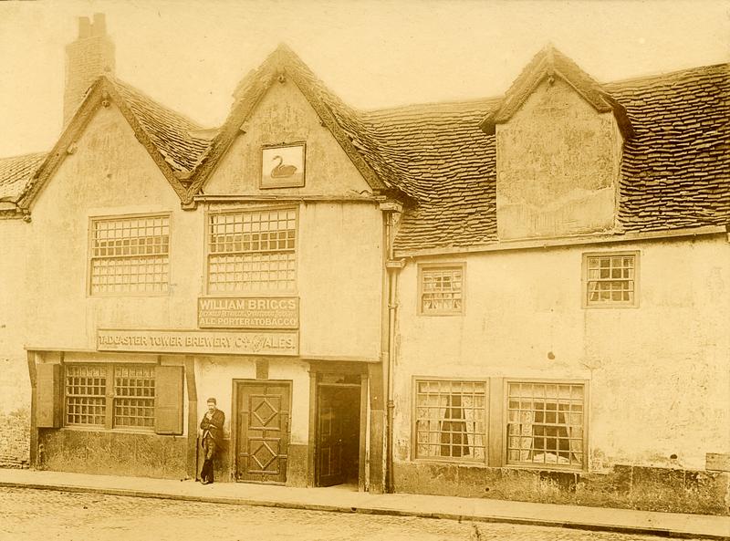 Man standing in front of The Black Swan Inn at Peasholme Green, c.1895.
