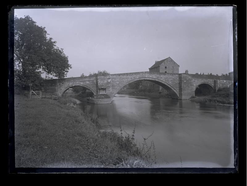 Unidentified stone bridge over a river, c.1900