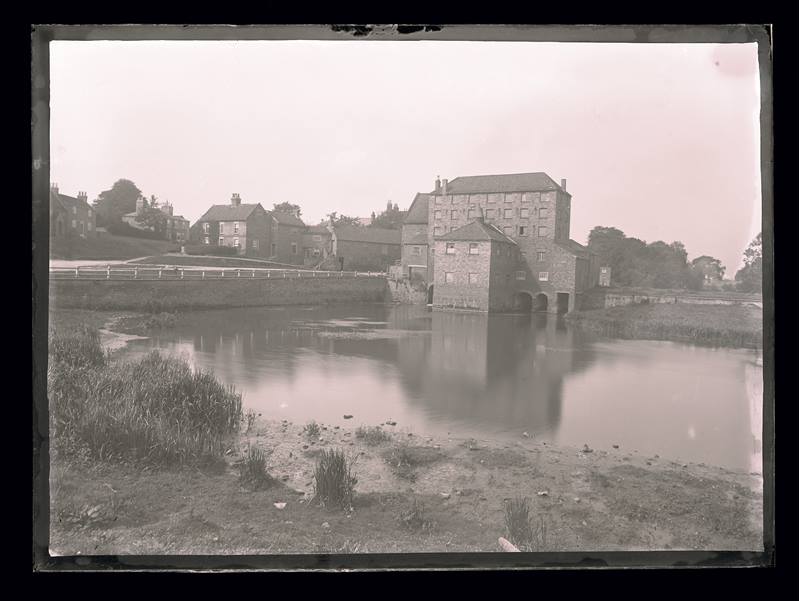 Village sitting on a riverbank, c.1900